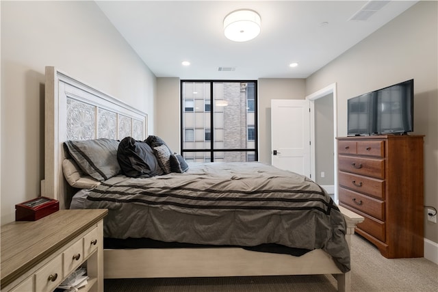 bedroom featuring light carpet