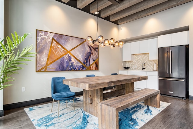 kitchen with high end fridge, white cabinets, dark wood-type flooring, and pendant lighting