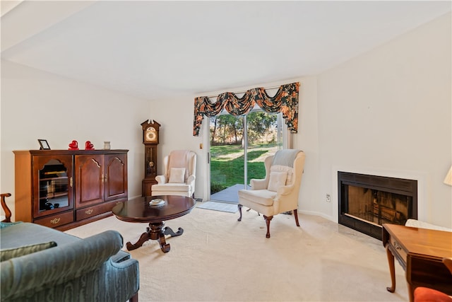 sitting room featuring light colored carpet