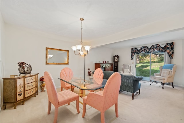 dining room with an inviting chandelier and light colored carpet