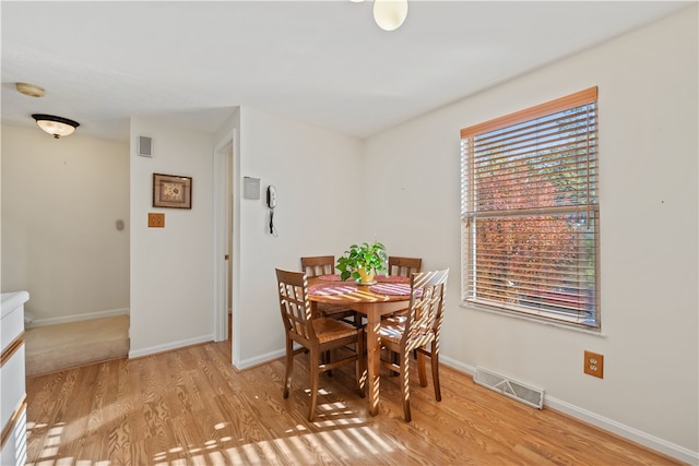 dining space with light hardwood / wood-style flooring