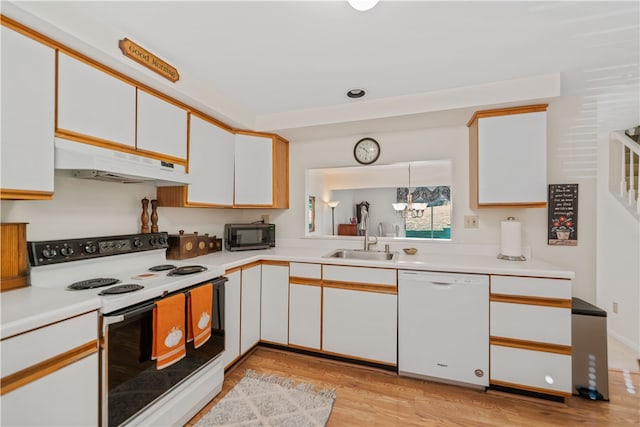 kitchen with white cabinetry, light hardwood / wood-style floors, a notable chandelier, sink, and white appliances