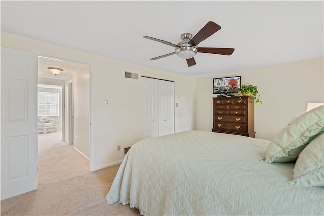 carpeted bedroom with a closet and ceiling fan