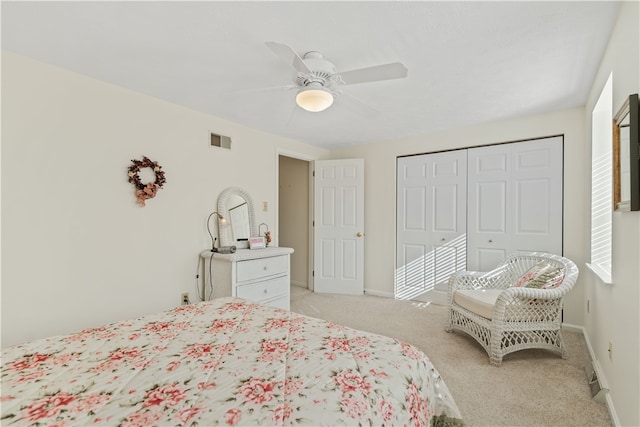 bedroom featuring light carpet, a closet, and ceiling fan