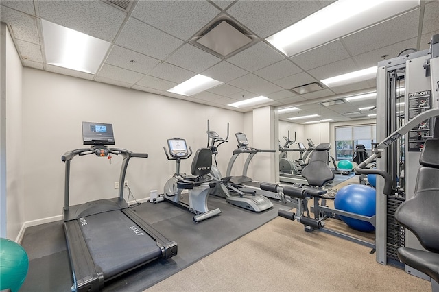 gym with a drop ceiling and carpet flooring