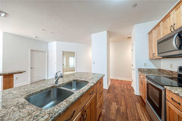 151 Fort Pitt Blvd Unit 401, Downtown Pgh, PA 15222 - kitchen featuring stainless steel appliances, a sink, dark wood-type flooring, dark stone counters, and baseboards