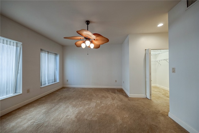 empty room with light carpet and ceiling fan