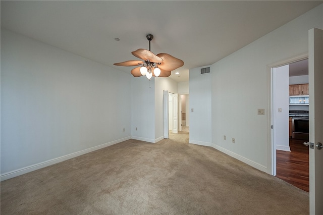 empty room with light carpet and ceiling fan