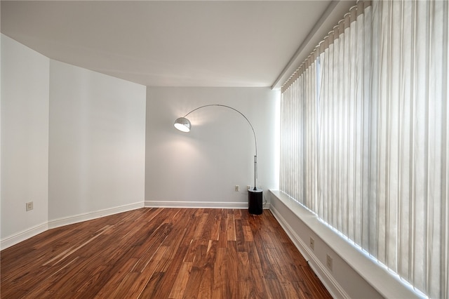 spare room with dark wood-type flooring