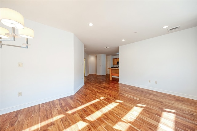 unfurnished room with hardwood / wood-style flooring