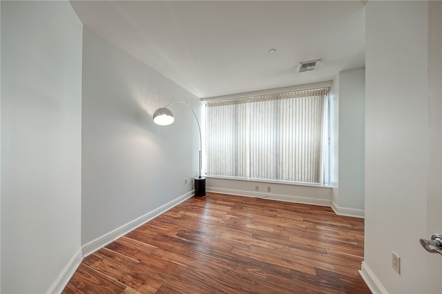 spare room featuring dark wood-type flooring