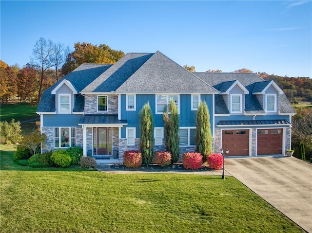 view of front of house with a front yard and a garage