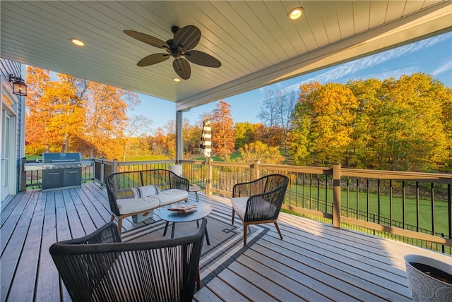 deck with ceiling fan and a lawn