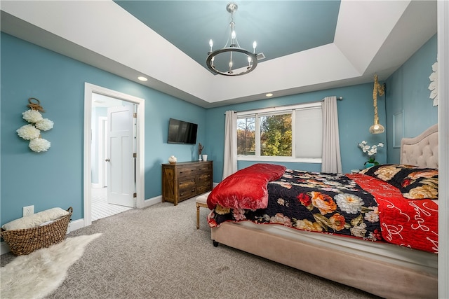 bedroom with a chandelier, carpet, and a raised ceiling