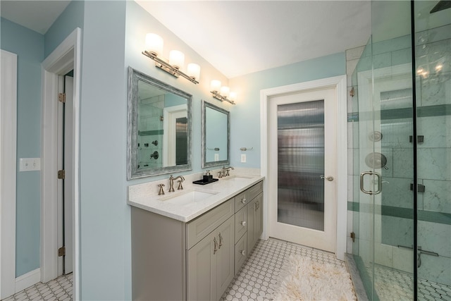 bathroom with vanity, tile patterned floors, and a shower with door