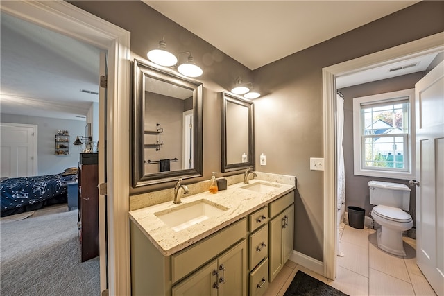 bathroom with vanity, toilet, and tile patterned flooring