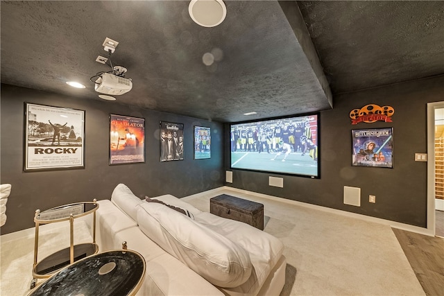 home theater with a textured ceiling and hardwood / wood-style flooring