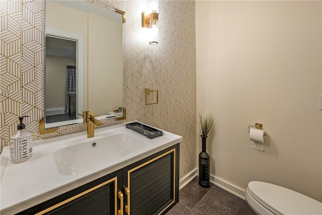 bathroom featuring toilet, vanity, and tile patterned floors