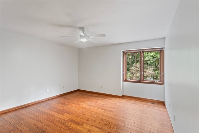 empty room featuring light wood-type flooring and ceiling fan