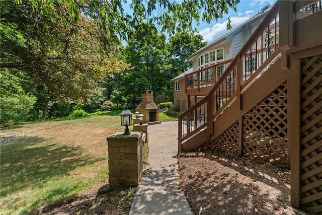 view of yard with an outdoor stone fireplace