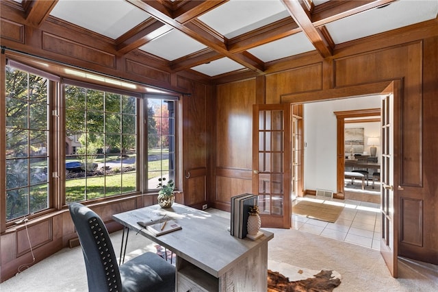 dining space featuring french doors, beam ceiling, a healthy amount of sunlight, and wood walls