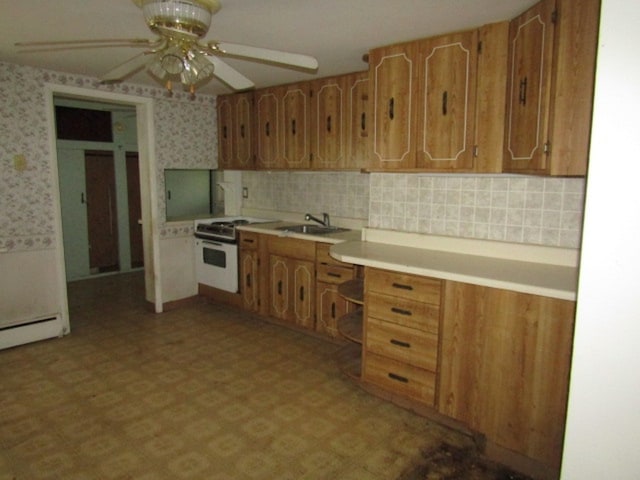 kitchen featuring sink, white range, and ceiling fan