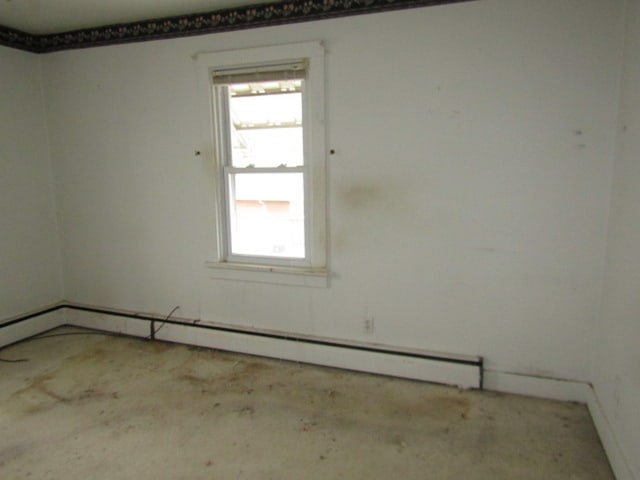 empty room featuring a baseboard heating unit