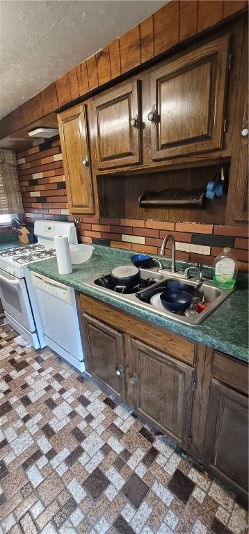 kitchen featuring white appliances and sink