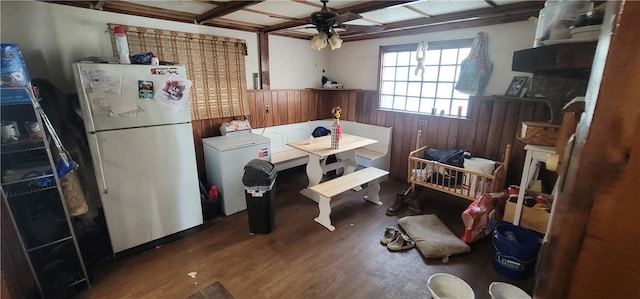 dining space featuring coffered ceiling, washer / dryer, beamed ceiling, hardwood / wood-style floors, and ceiling fan