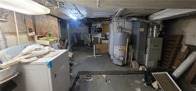 basement with water heater, heating unit, and refrigerator