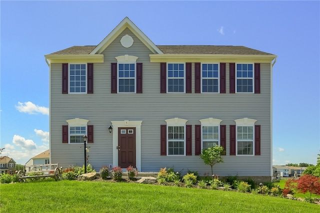 colonial-style house with a front yard