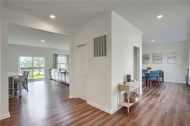 hall with crown molding and hardwood / wood-style floors