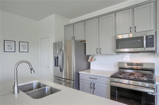 kitchen featuring sink, crown molding, light stone countertops, and stainless steel appliances