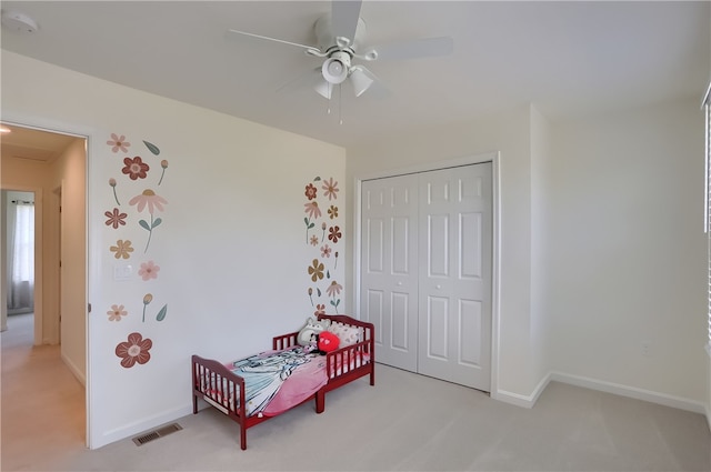 carpeted bedroom featuring a closet and ceiling fan