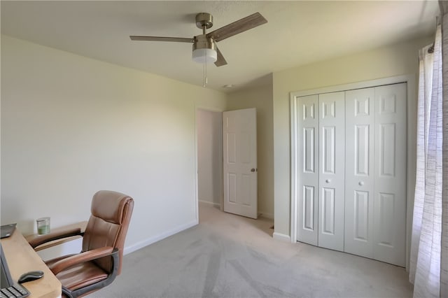 carpeted office space featuring ceiling fan