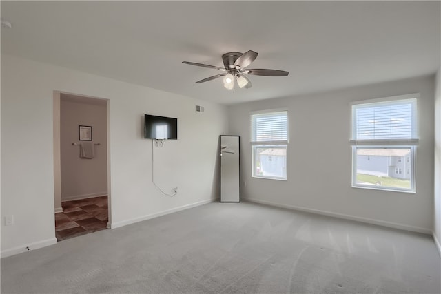 empty room featuring carpet flooring and ceiling fan