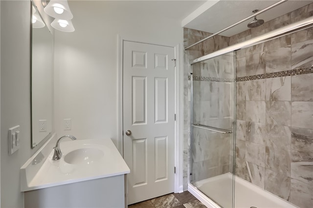 bathroom featuring vanity and a shower with shower door