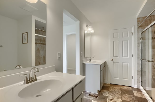 bathroom with vanity and a shower with shower door