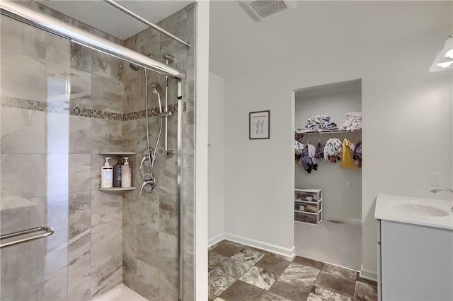 bathroom with a shower with door and vanity