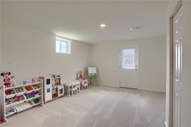 rec room with light carpet and plenty of natural light