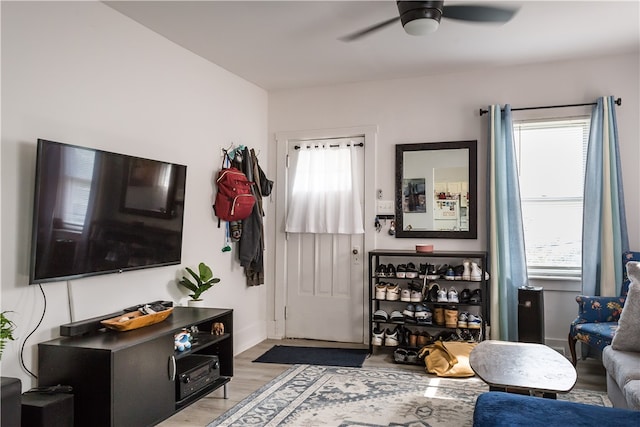 living room featuring plenty of natural light, ceiling fan, and light hardwood / wood-style flooring