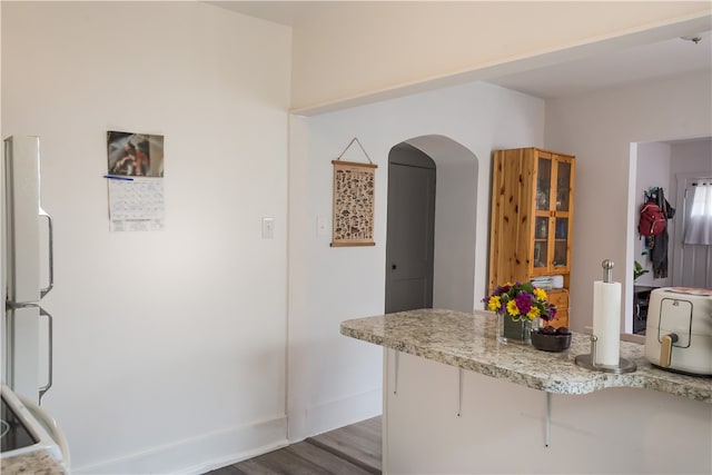 kitchen featuring dark hardwood / wood-style floors and white fridge