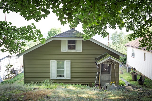 rear view of property with central AC