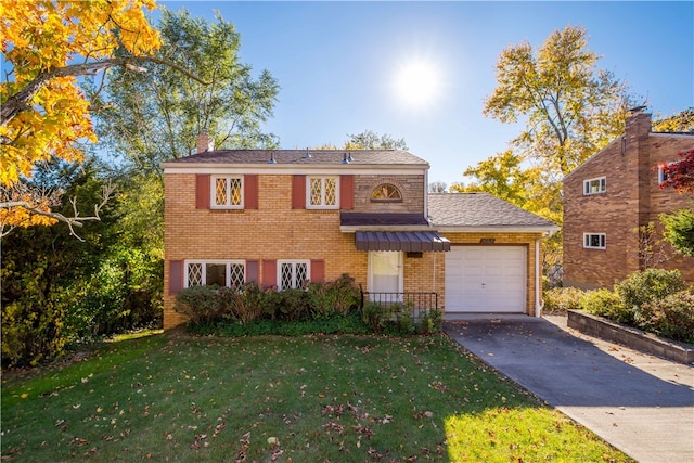 view of front of property with a front yard and a garage