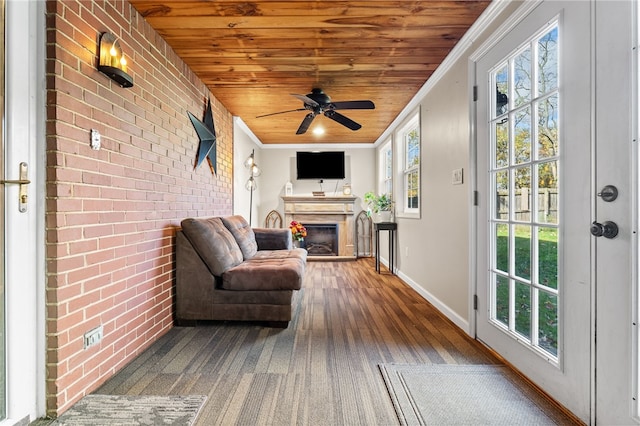 sunroom featuring wooden ceiling and ceiling fan