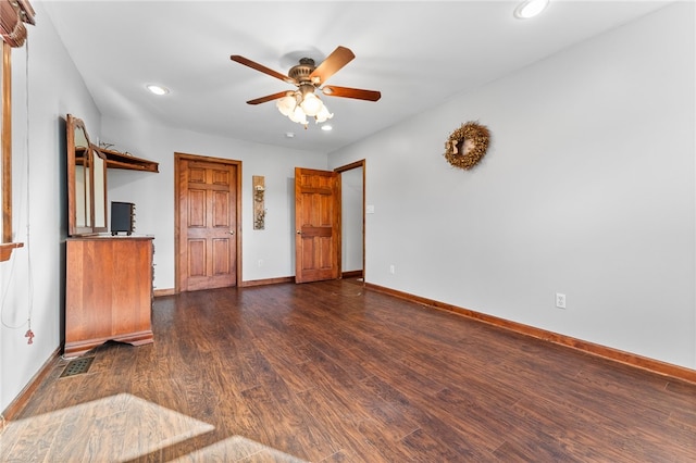 unfurnished living room with dark hardwood / wood-style floors and ceiling fan