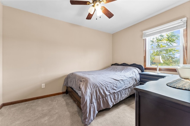 bedroom featuring light carpet and ceiling fan