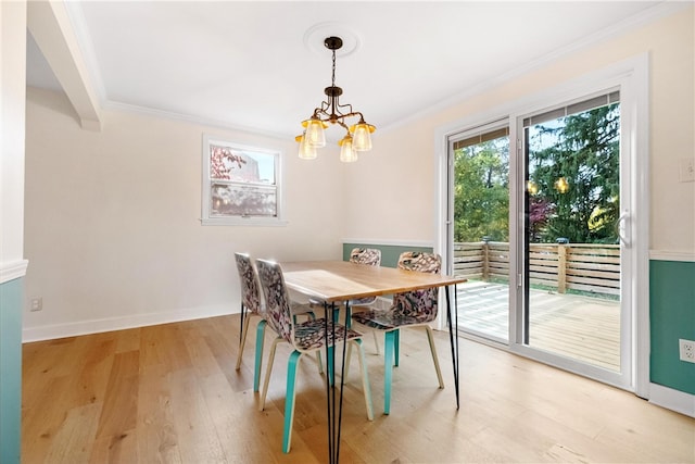 dining room featuring crown molding, a chandelier, and light wood-type flooring