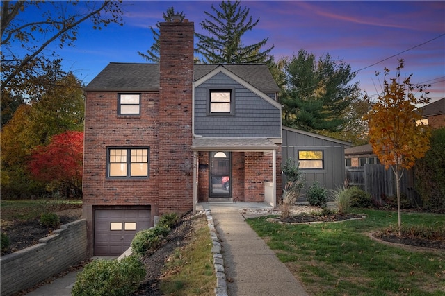 view of property with a lawn and a garage