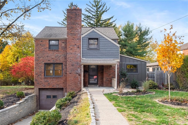 view of property featuring a front yard and a garage